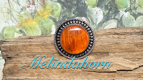 R107, orange spiny round ring